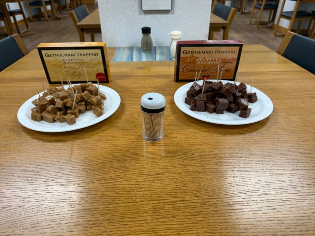 Two plates of cubed fudge on a wooden dining table
