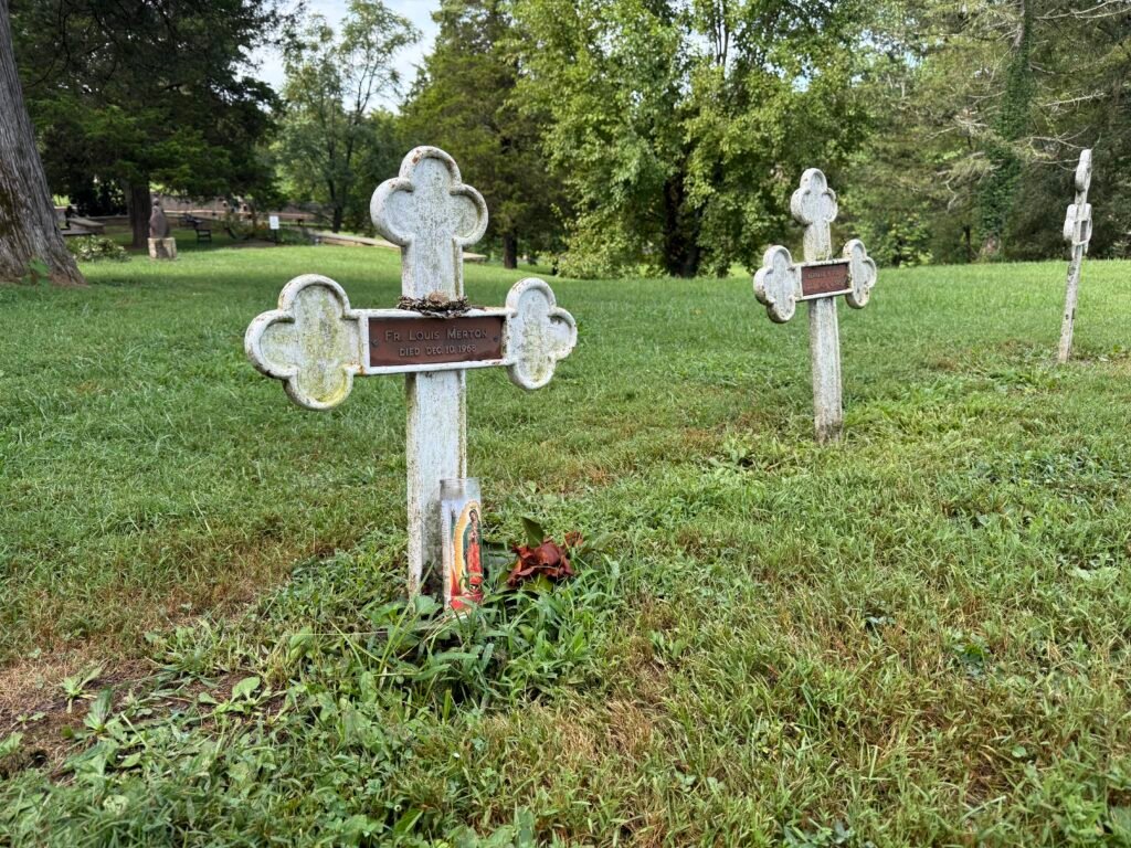 Row of white cemetery crosses along the base of the Abbey building
